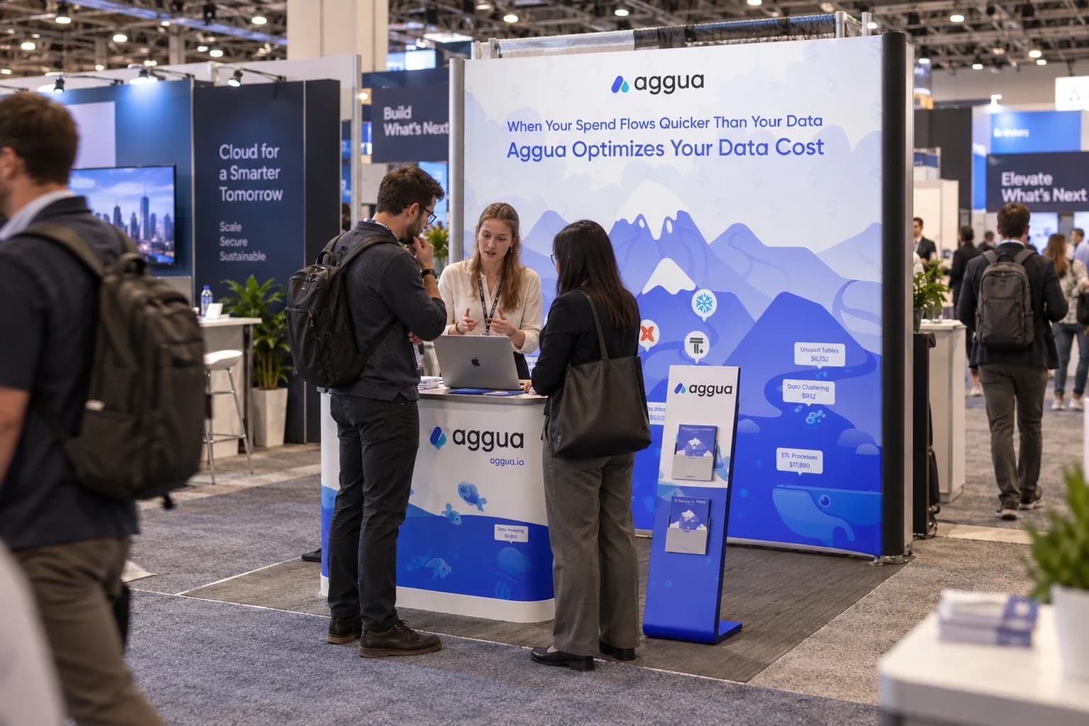 Attendees discussing a demo at the Aggua exhibition stand.