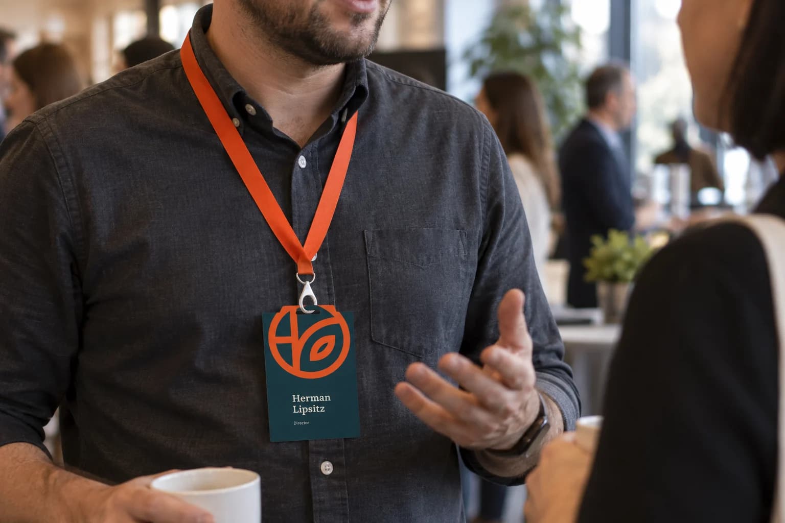 An event badge worn during a networking conversation.