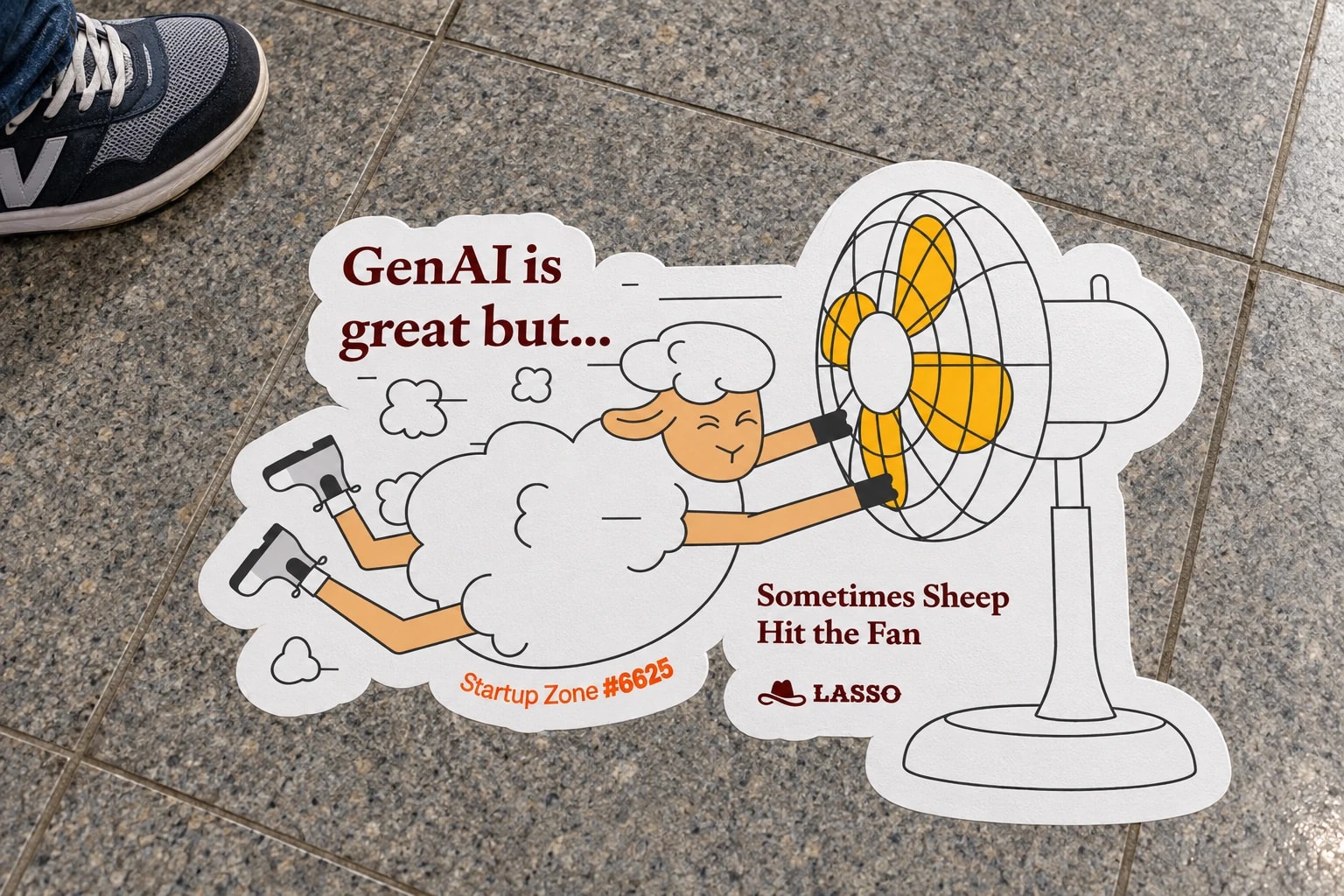 A large Lasso floor sticker showing an illustrated sheep and a fan at a conference.